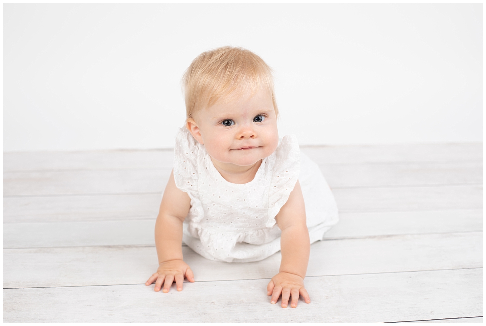 Crawling baby in white dress