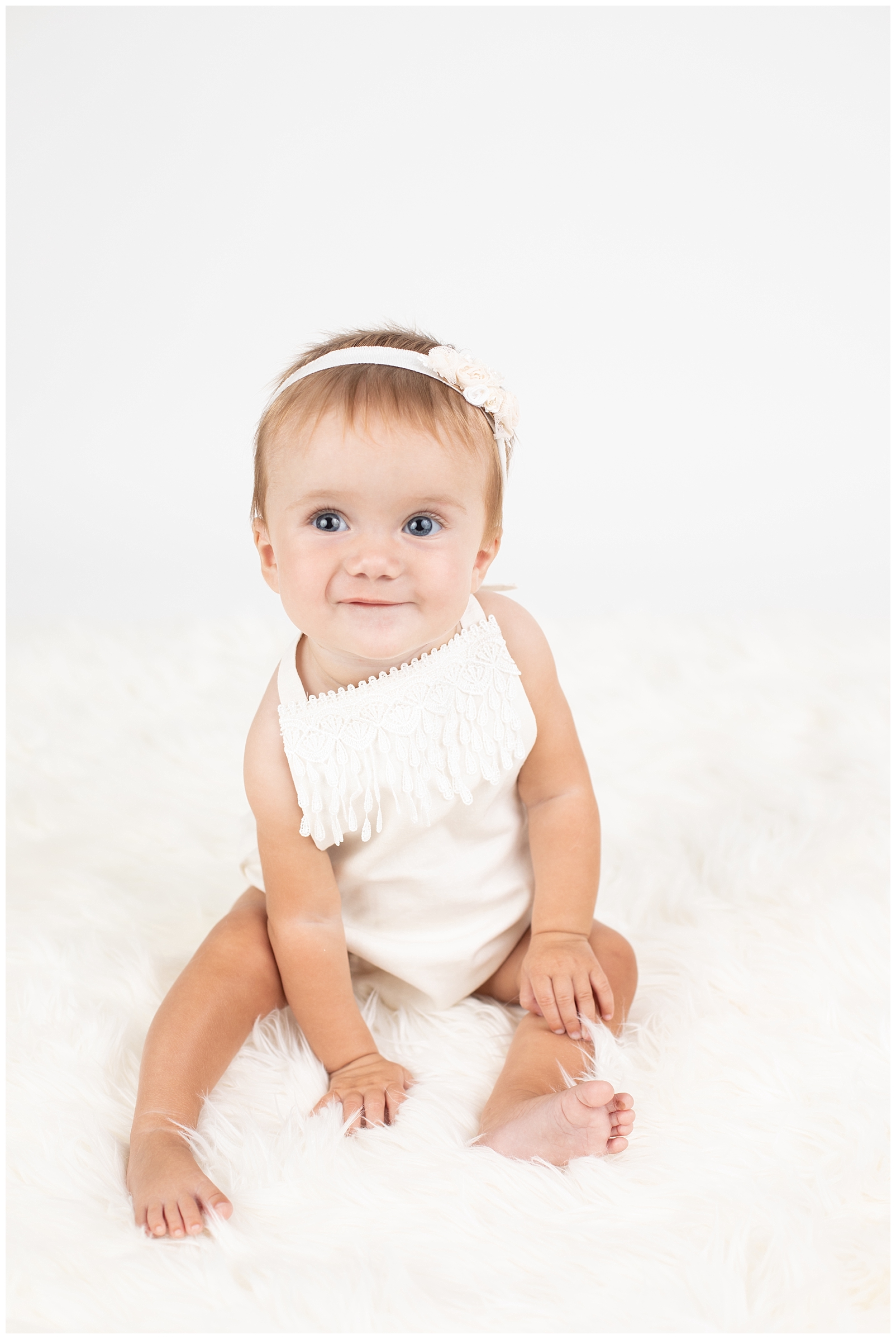 Smiling baby with a lace romper