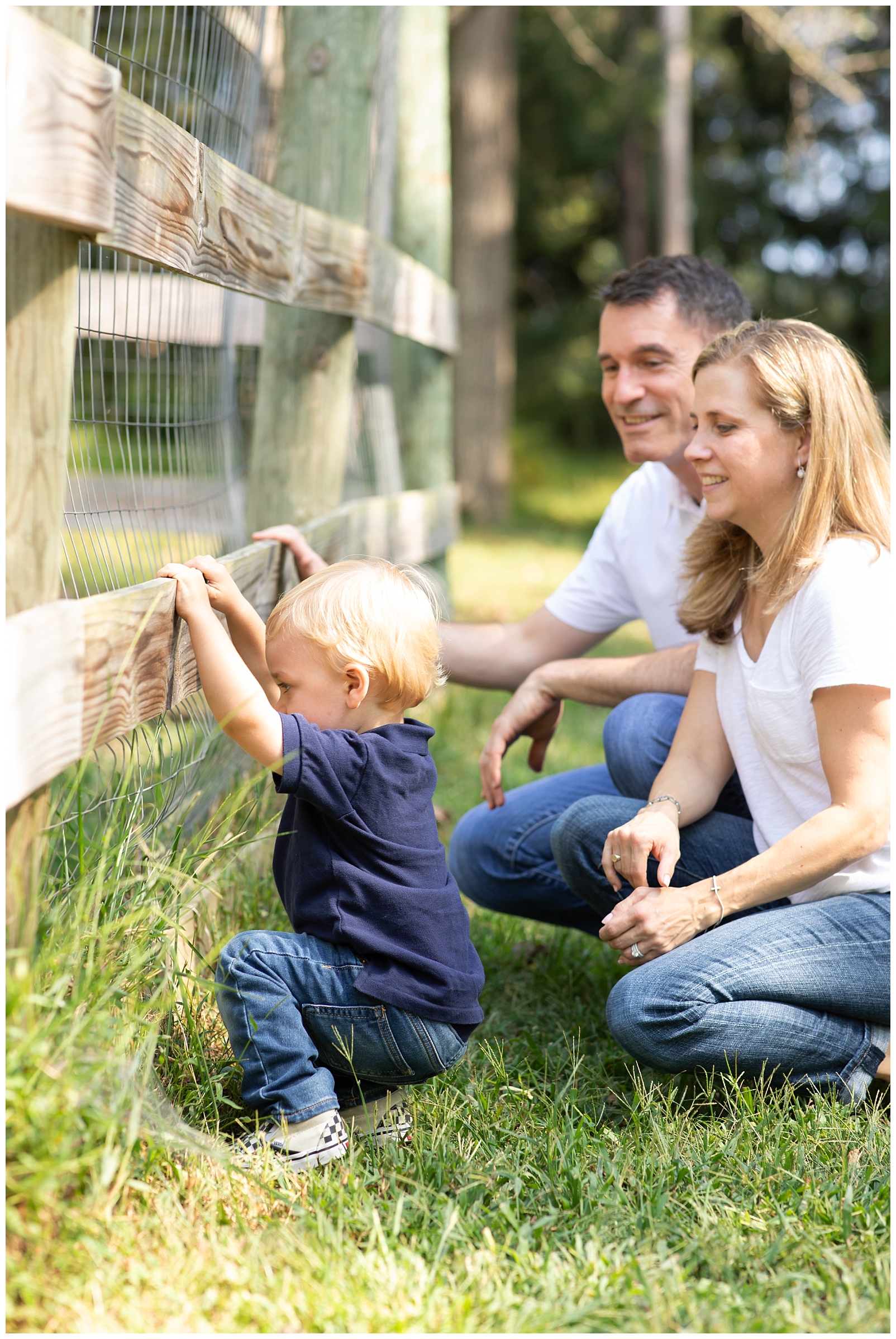 Boy and parents looking through a fence