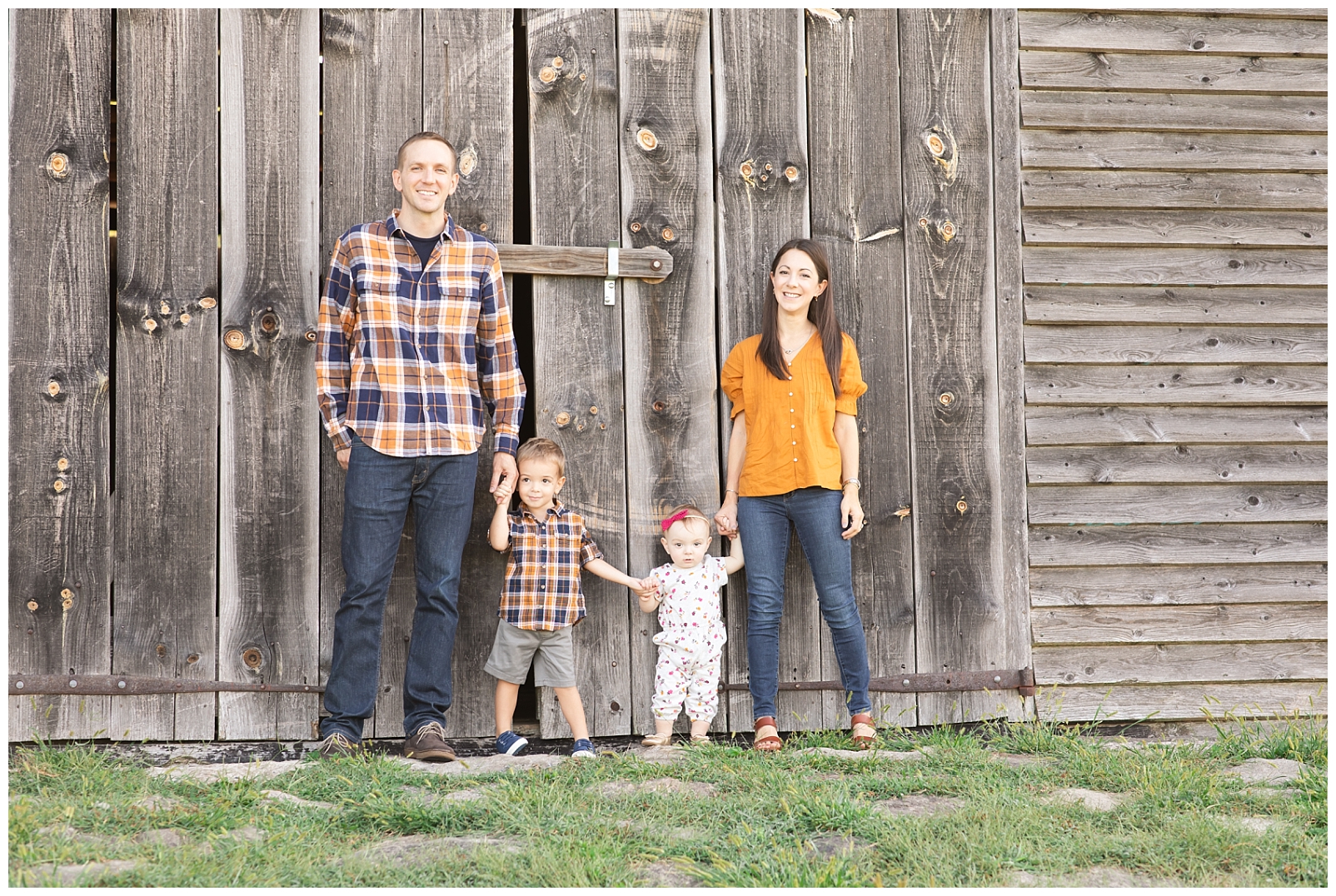 family of four standing in front of barn at the Howard County Conservancy