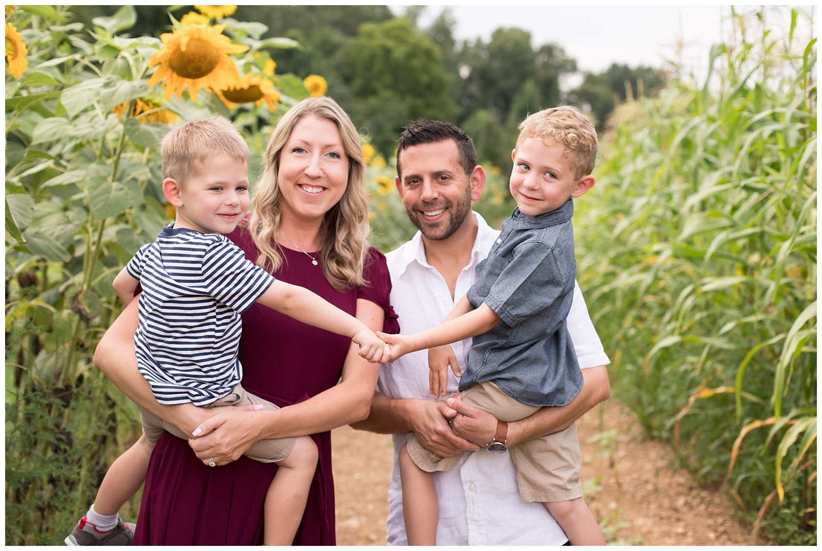 beautiful family smiling with sunflowers
