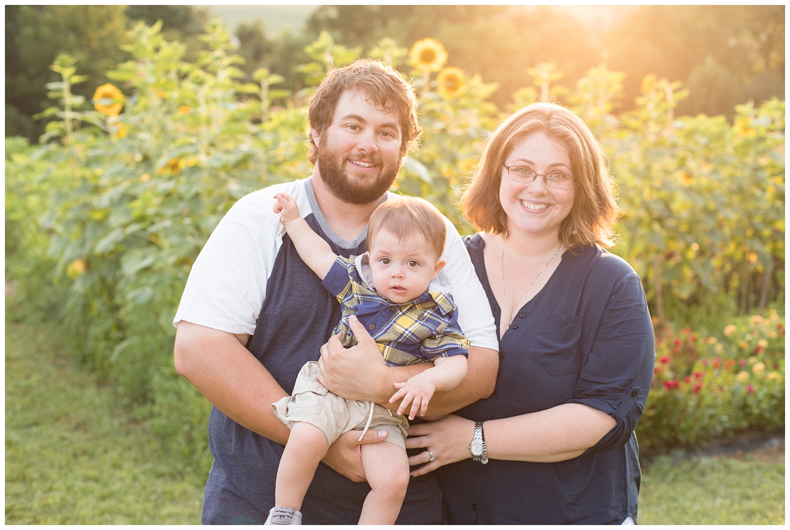 Sunflower field sunset with family of three smiling