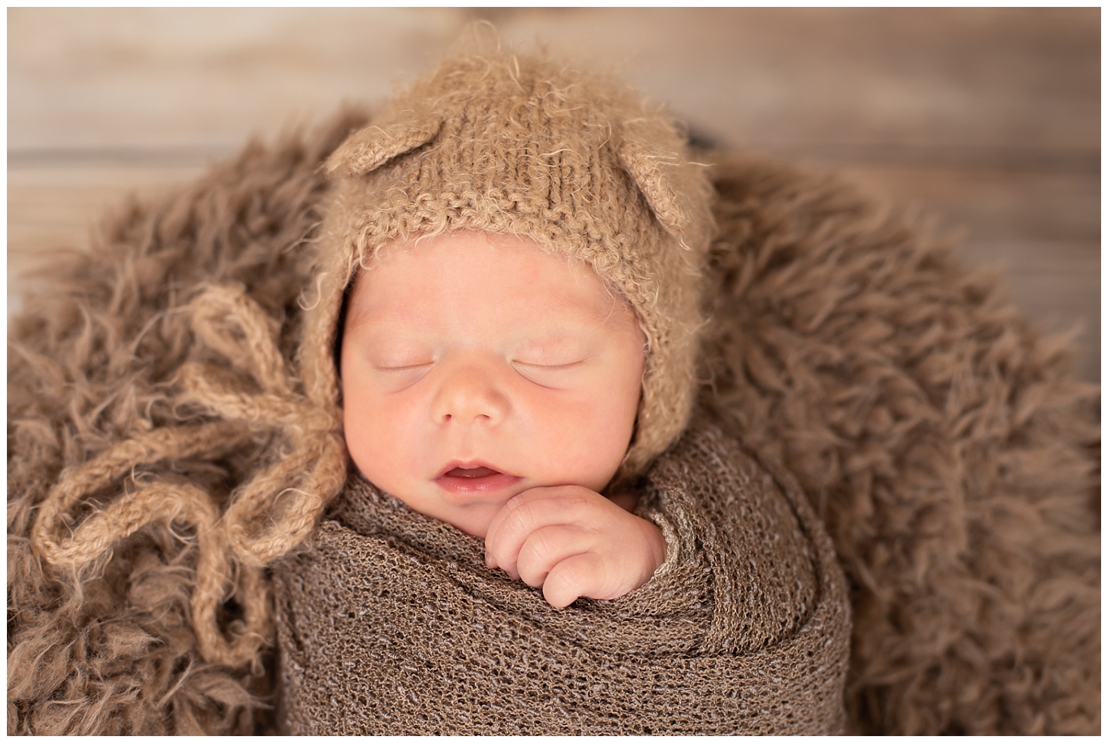 newborn sleeping with teddy bear hat