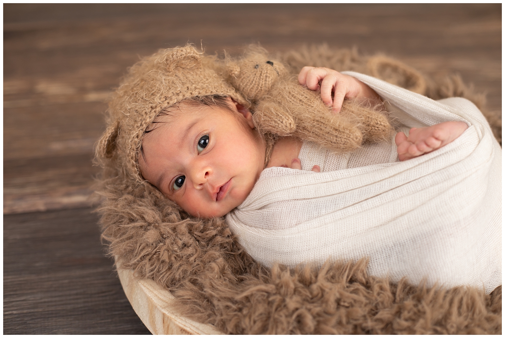 newborn with teddy bear hat and teddy bear