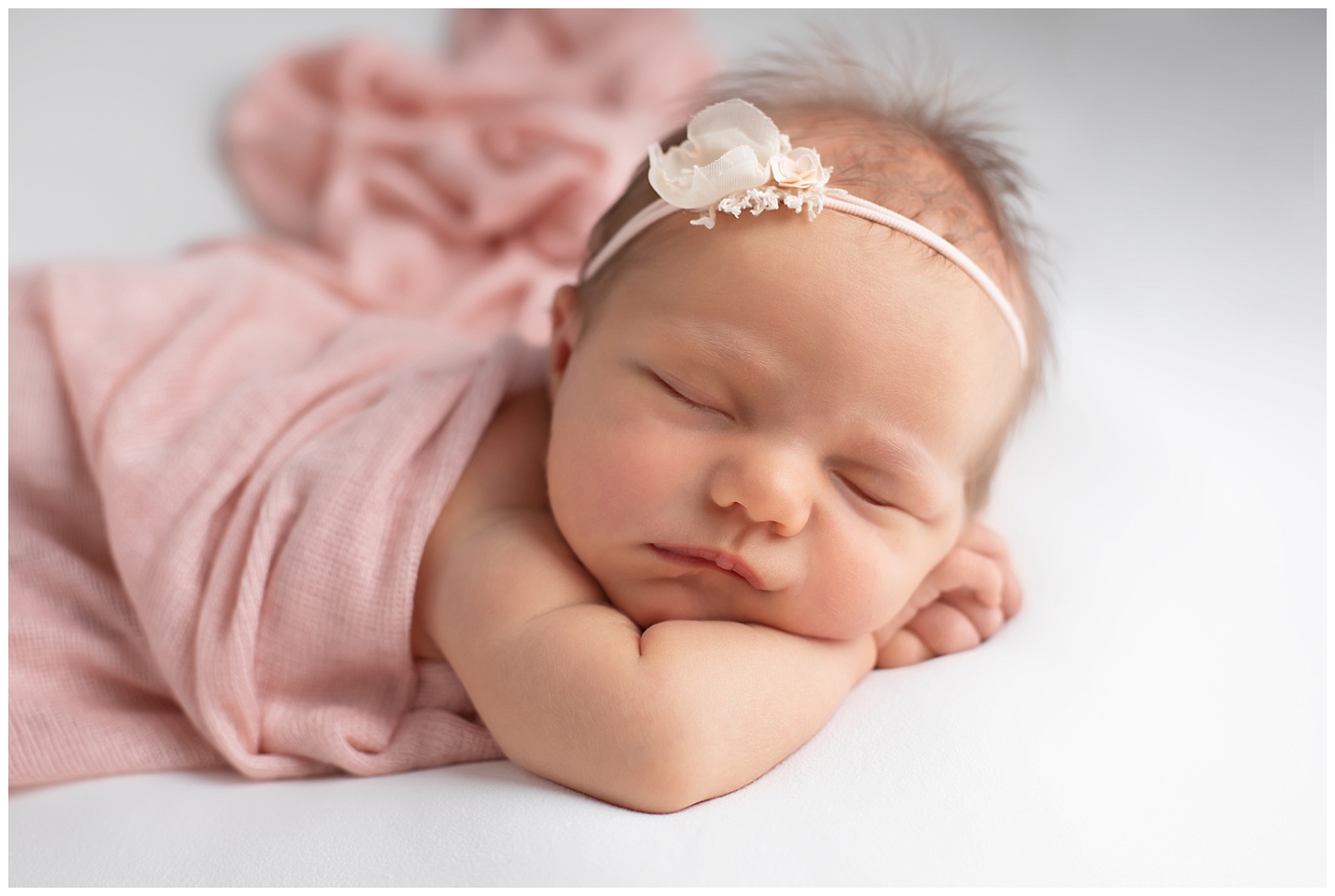 Newborn girl in pink wrap
