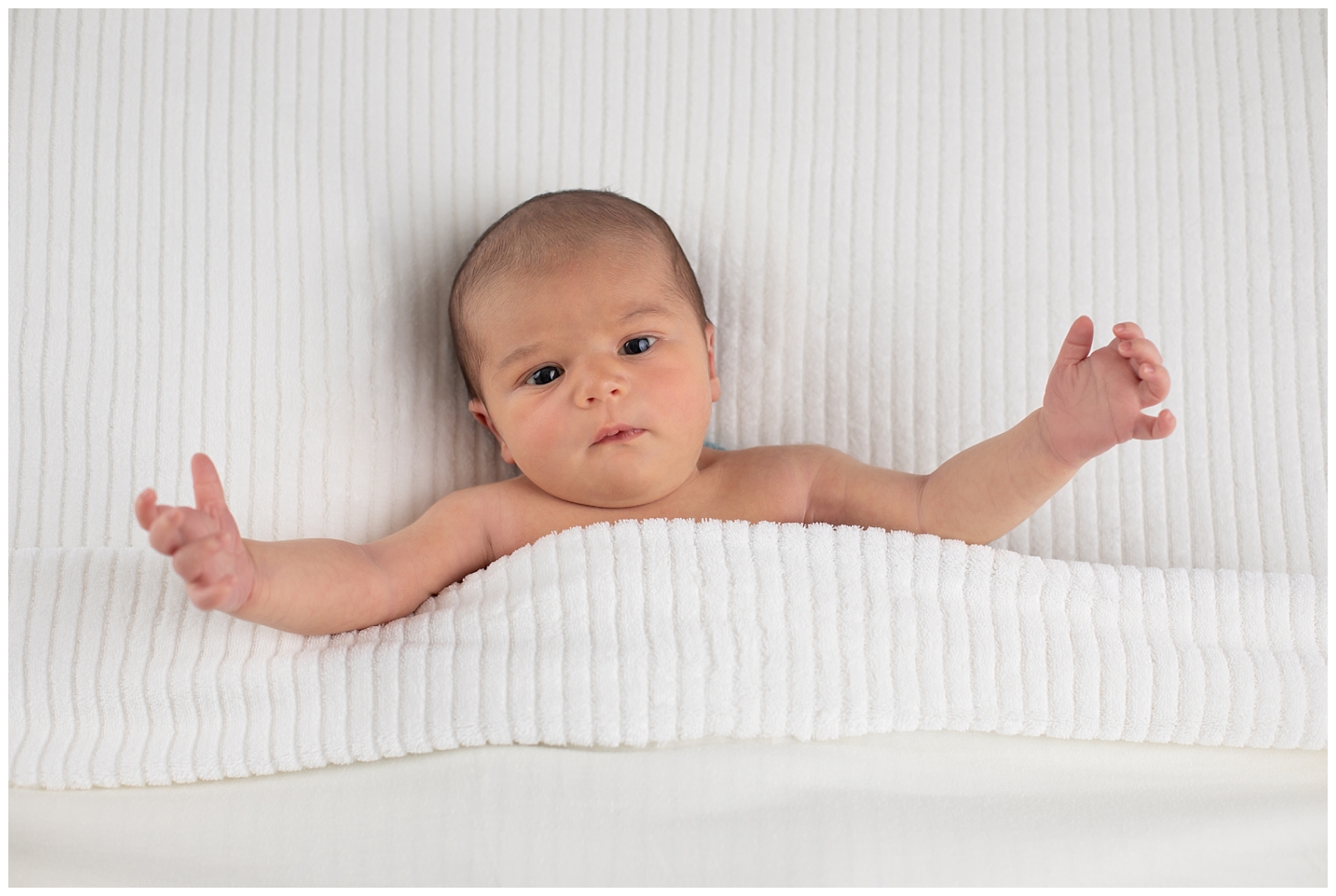 Newborn with striped blanket