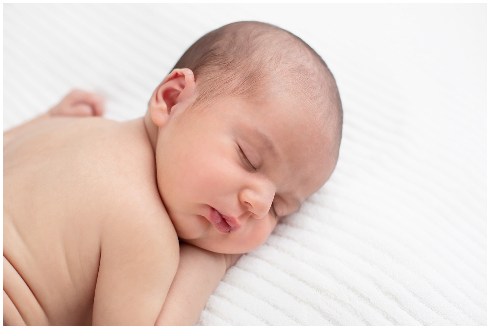 newborn on tummy sleeping