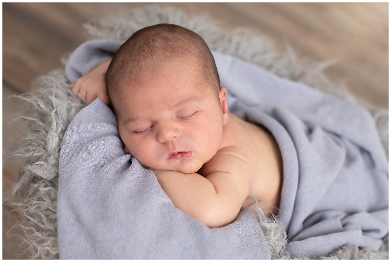 newborn sleeping chin on hands pose