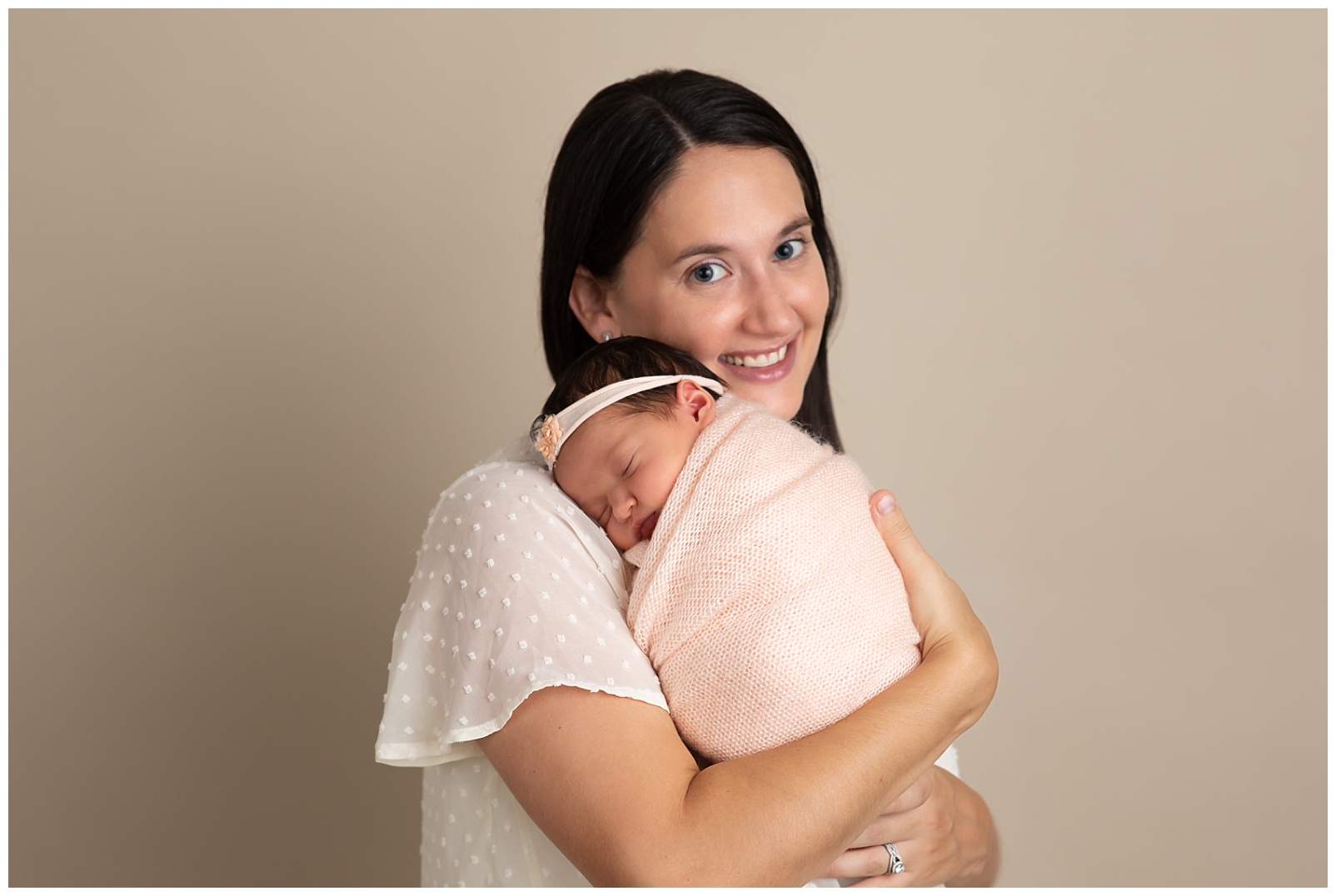 mom holding newborn girl