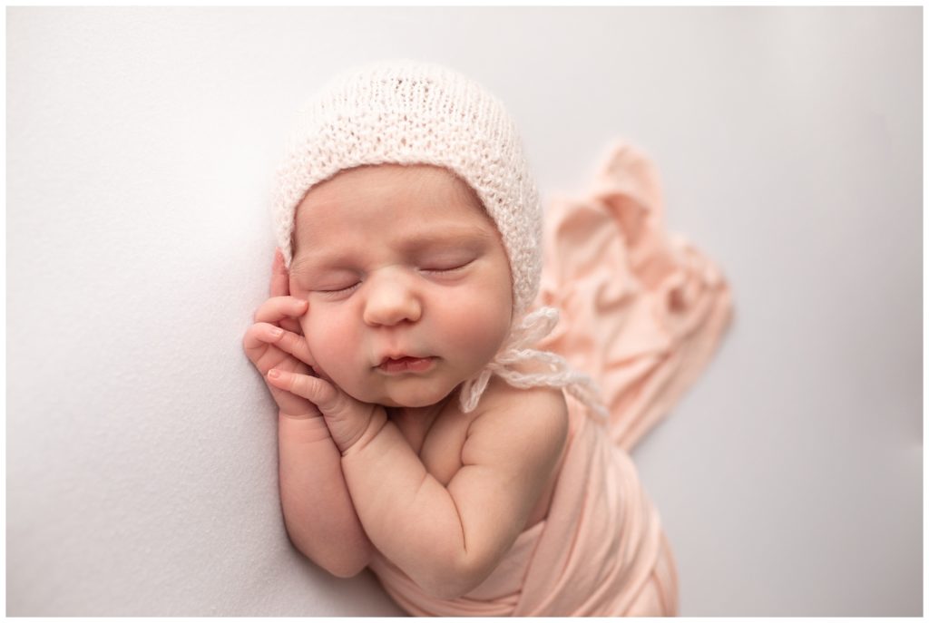 newborn wearing bonnet