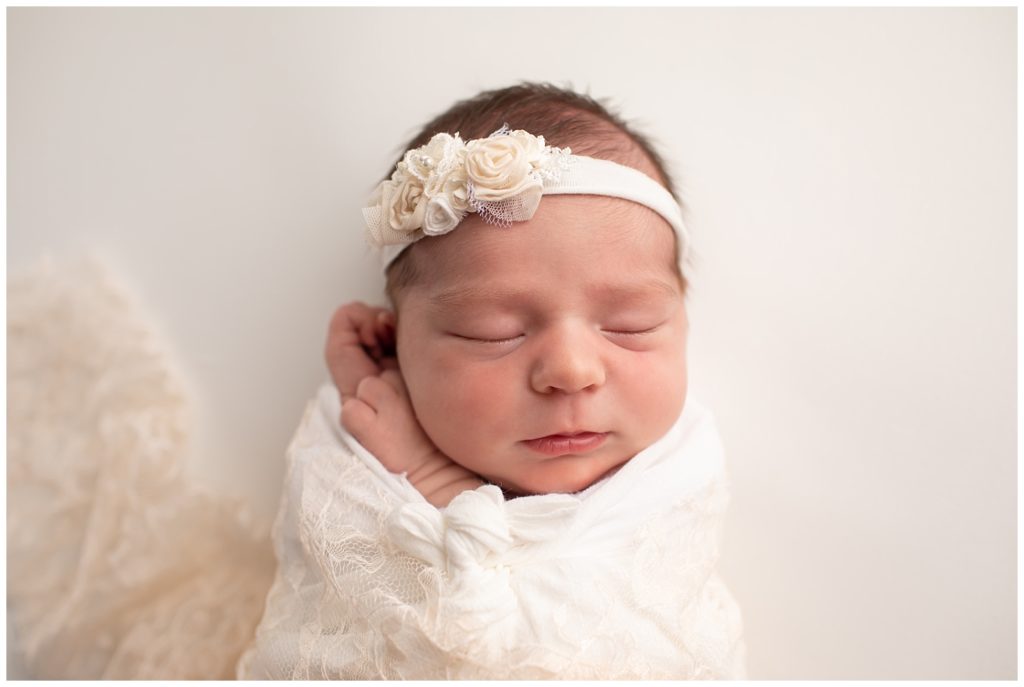 newborn with lace wrap and headband