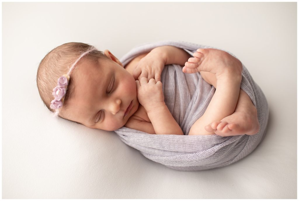 newborn with lavender floral headband