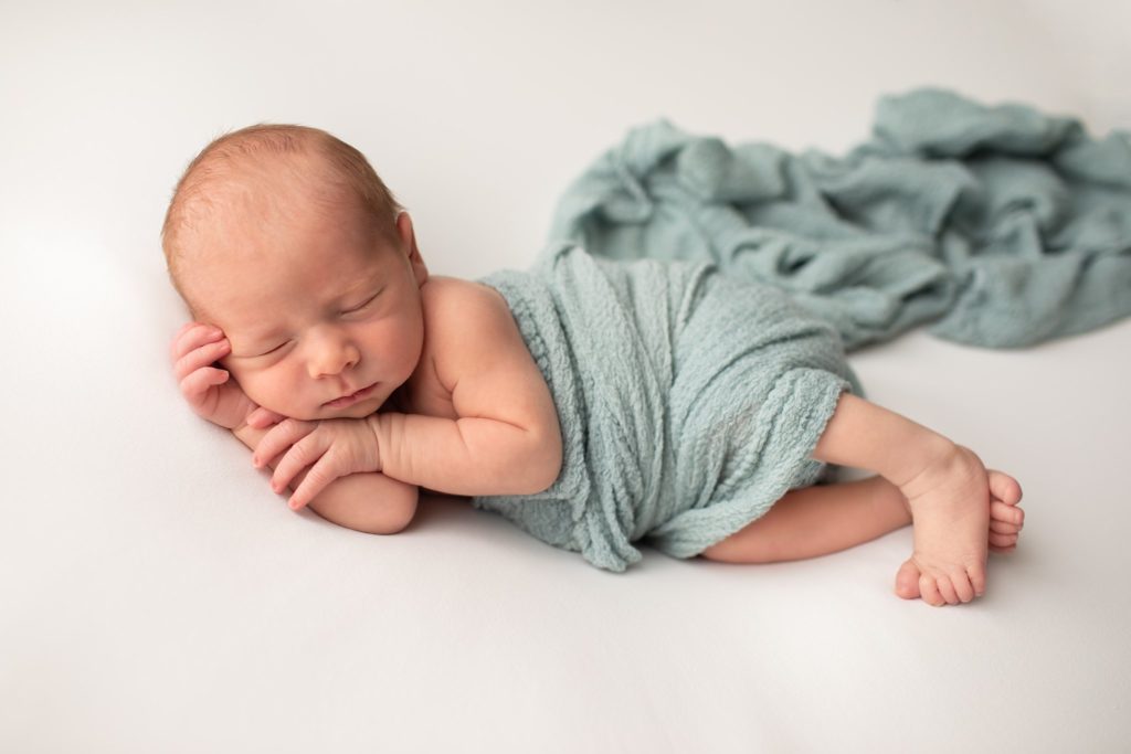 Newborn boy sleeping in wrap