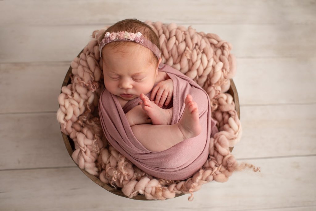 Newborn baby wearing the Hattie Headband with floral fabric designs