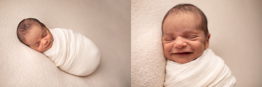 newborn smiling on soft fabric