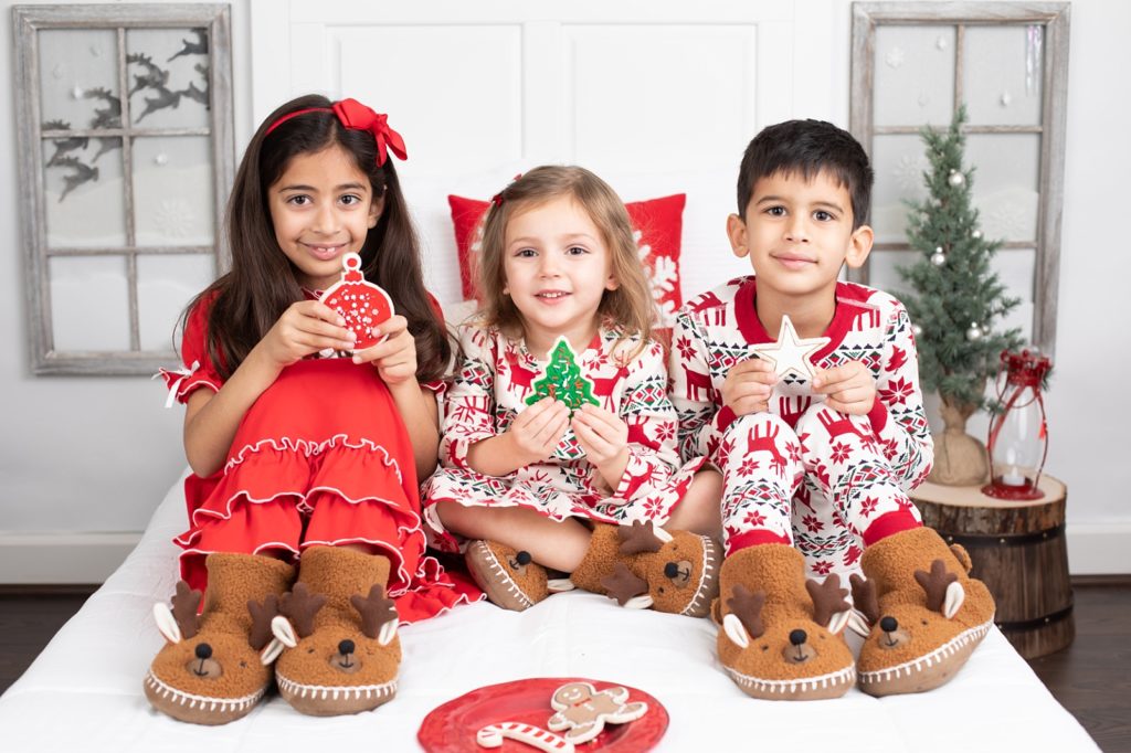 3 children holding pretend Christmas cookies
