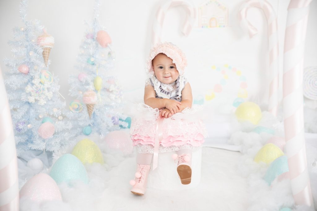 Baby girl wearing a pink, white and gray decorative dress