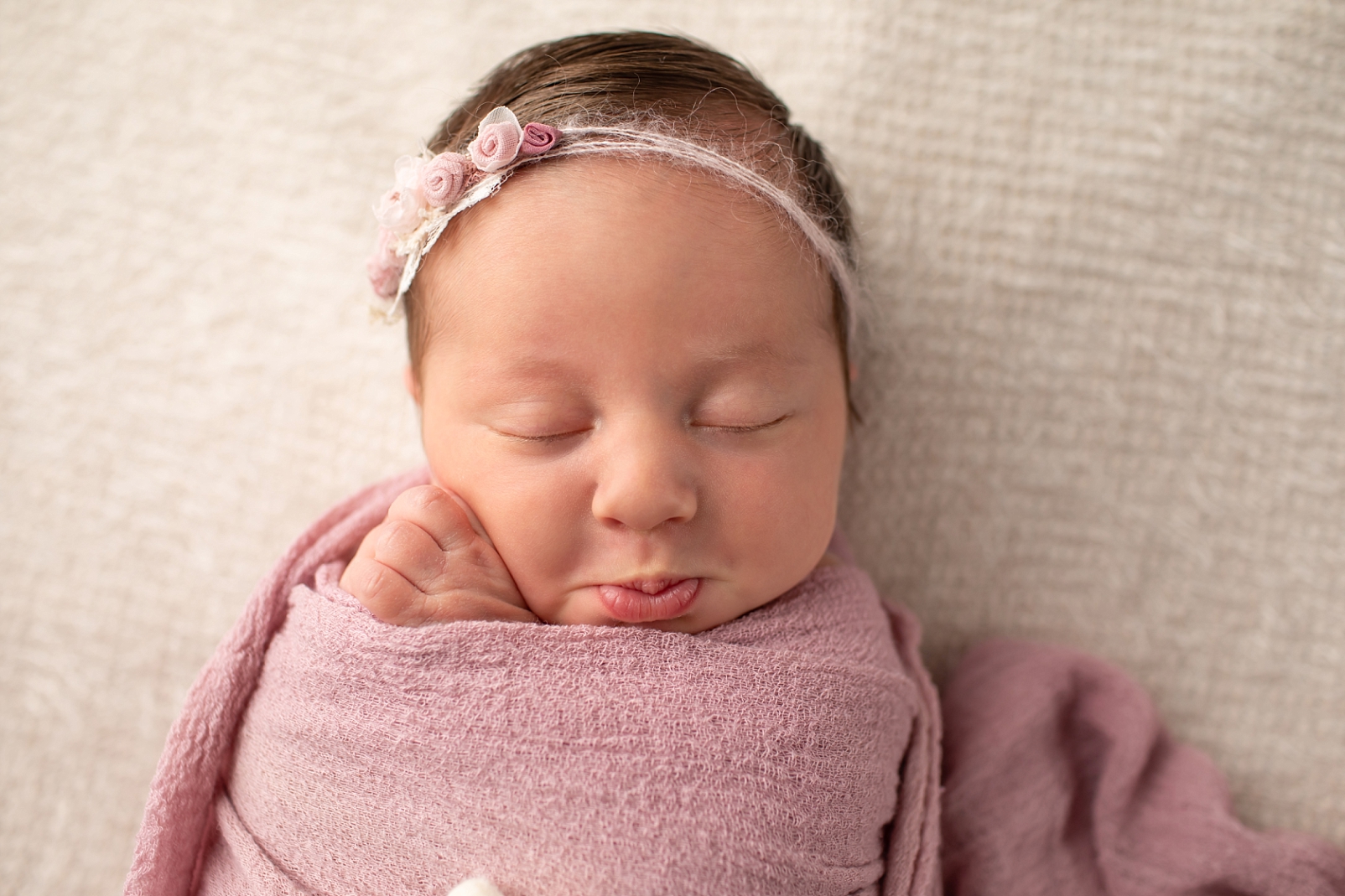 sleeping newborn with pout on face
