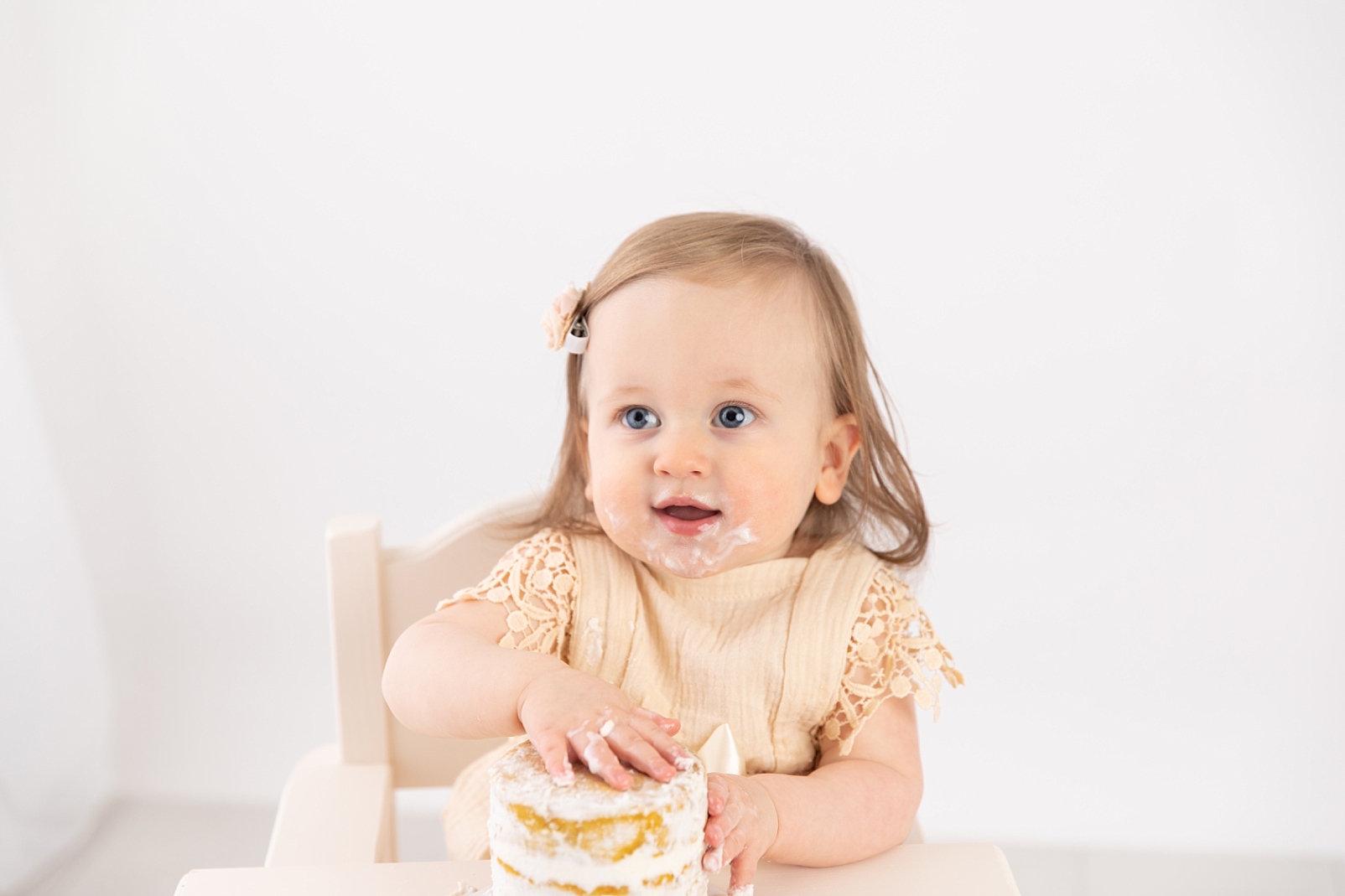 baby smiling with cake