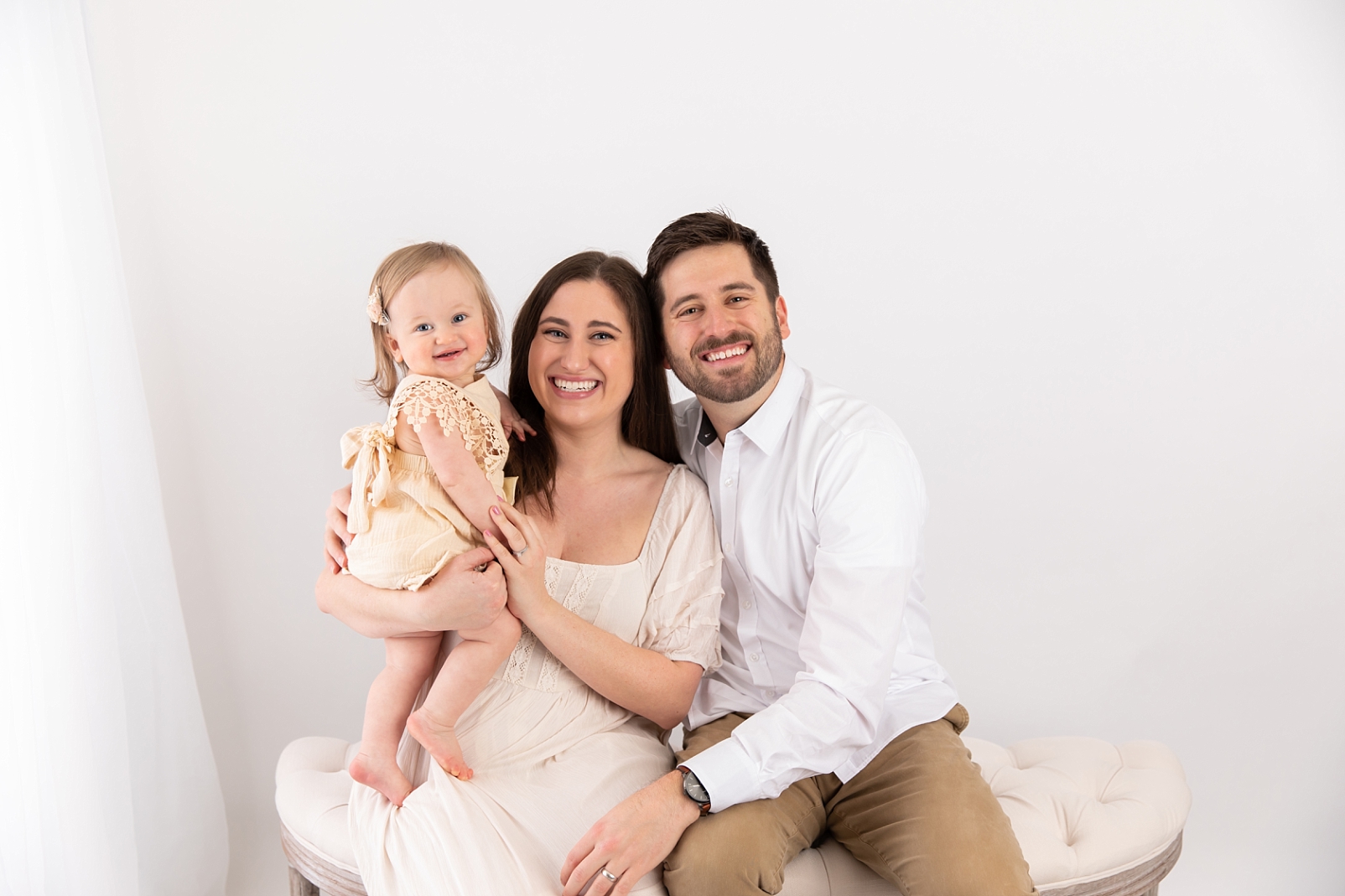 family smiling for first birthday portraits