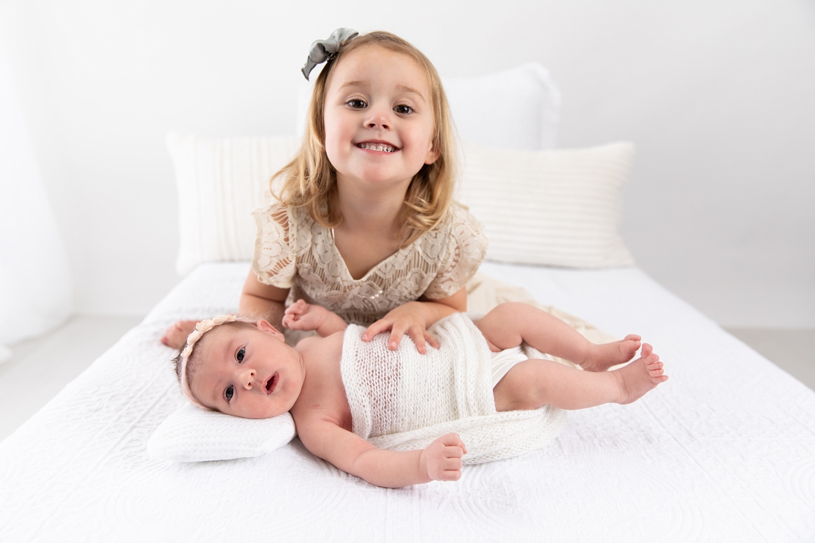 Little girl with her newborn sister with Ellicott City Newborn Photographer
