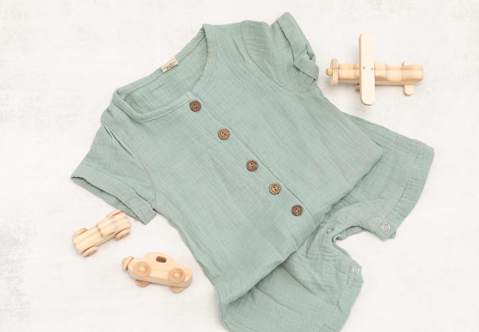 dusty blue green boys romper with wooden toys
