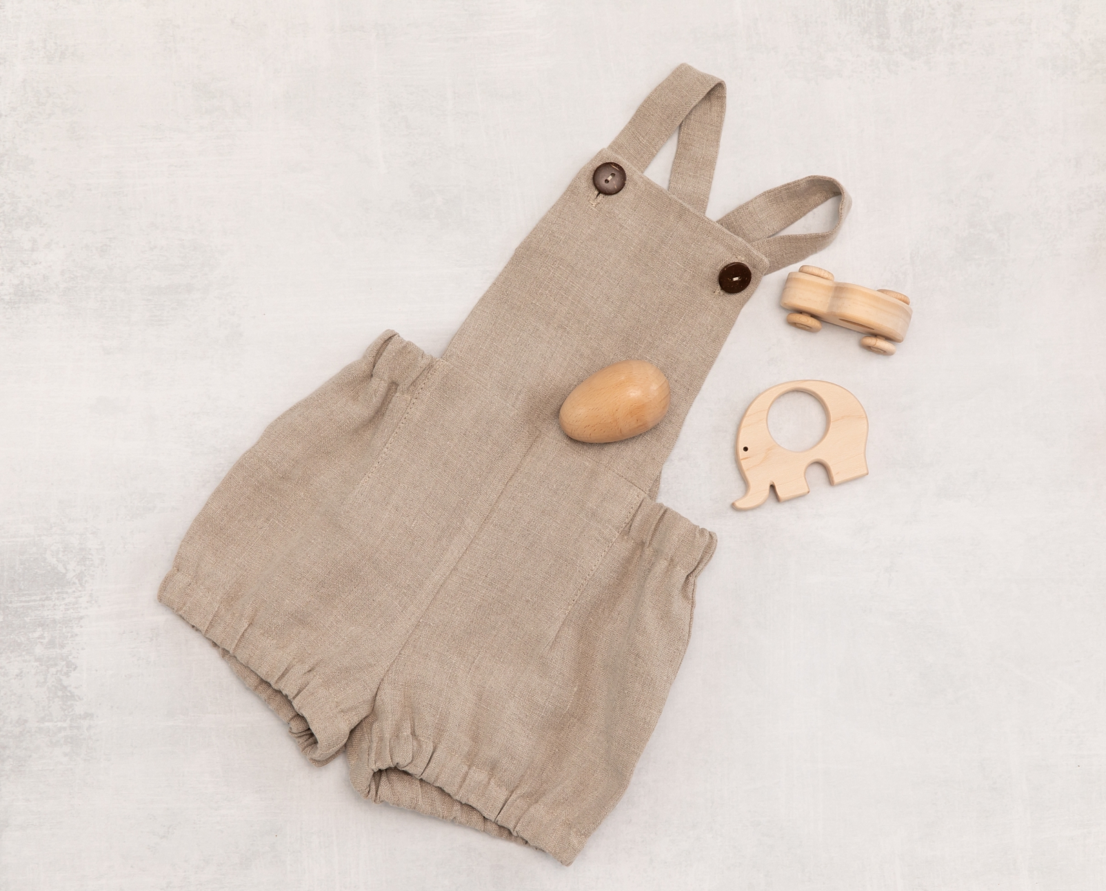 linen romper with wooden teether and rattle - Howard County Baby photographer
