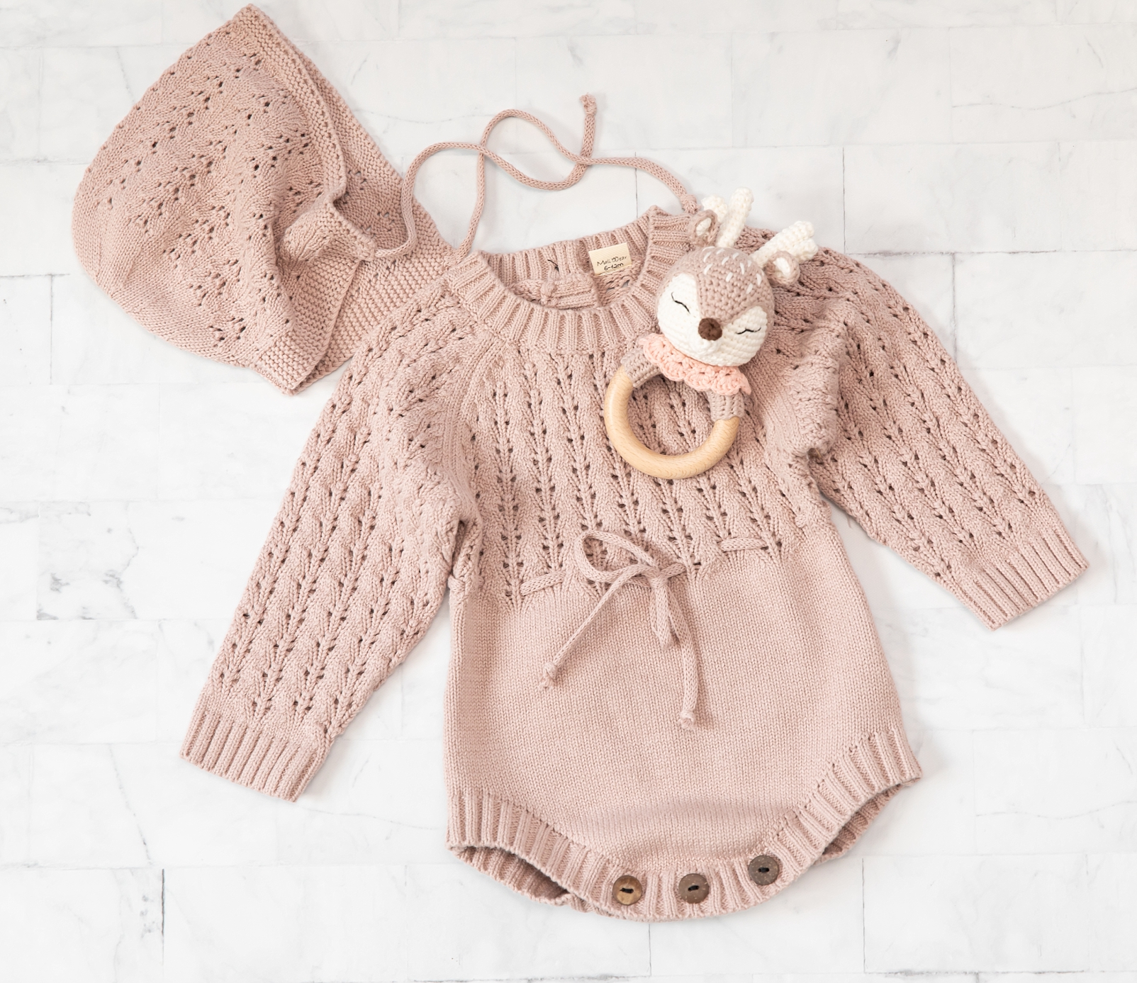 knit baby outfit, bonnet, and teether in mauve