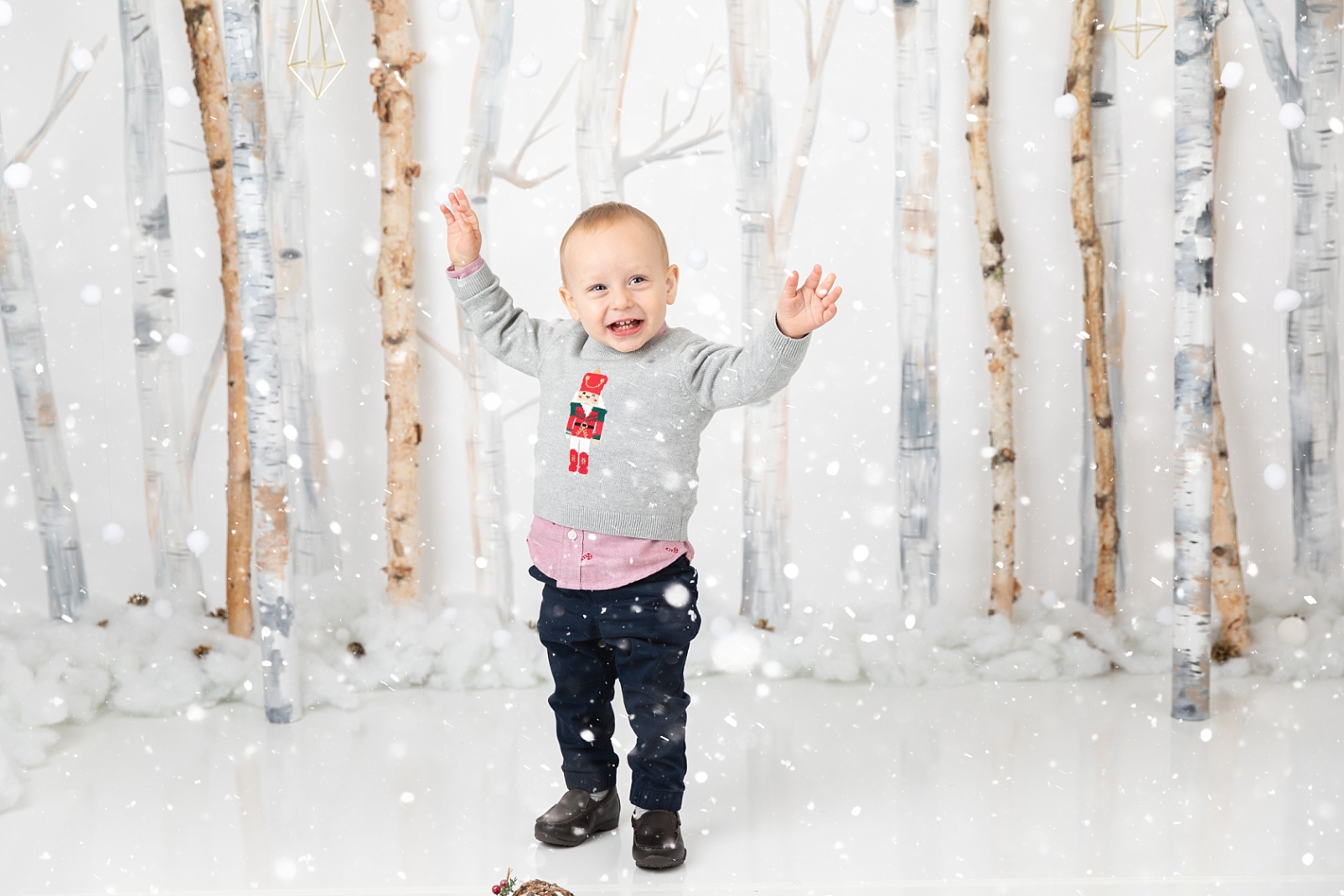 boy standing in front of birch trees and snowballs for Christmas Studio Minis Maryland