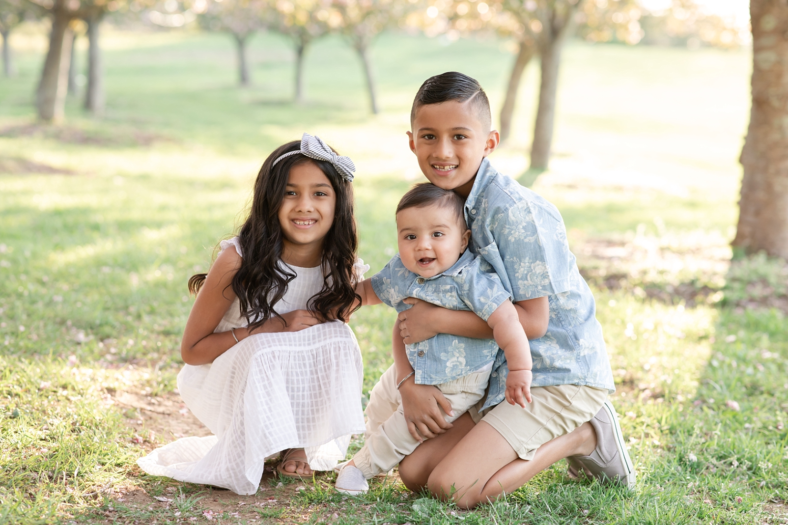 Spring portraits of a 3 children under cherry blossom trees with Maryland Family Photographer | Rebecca Leigh Photography