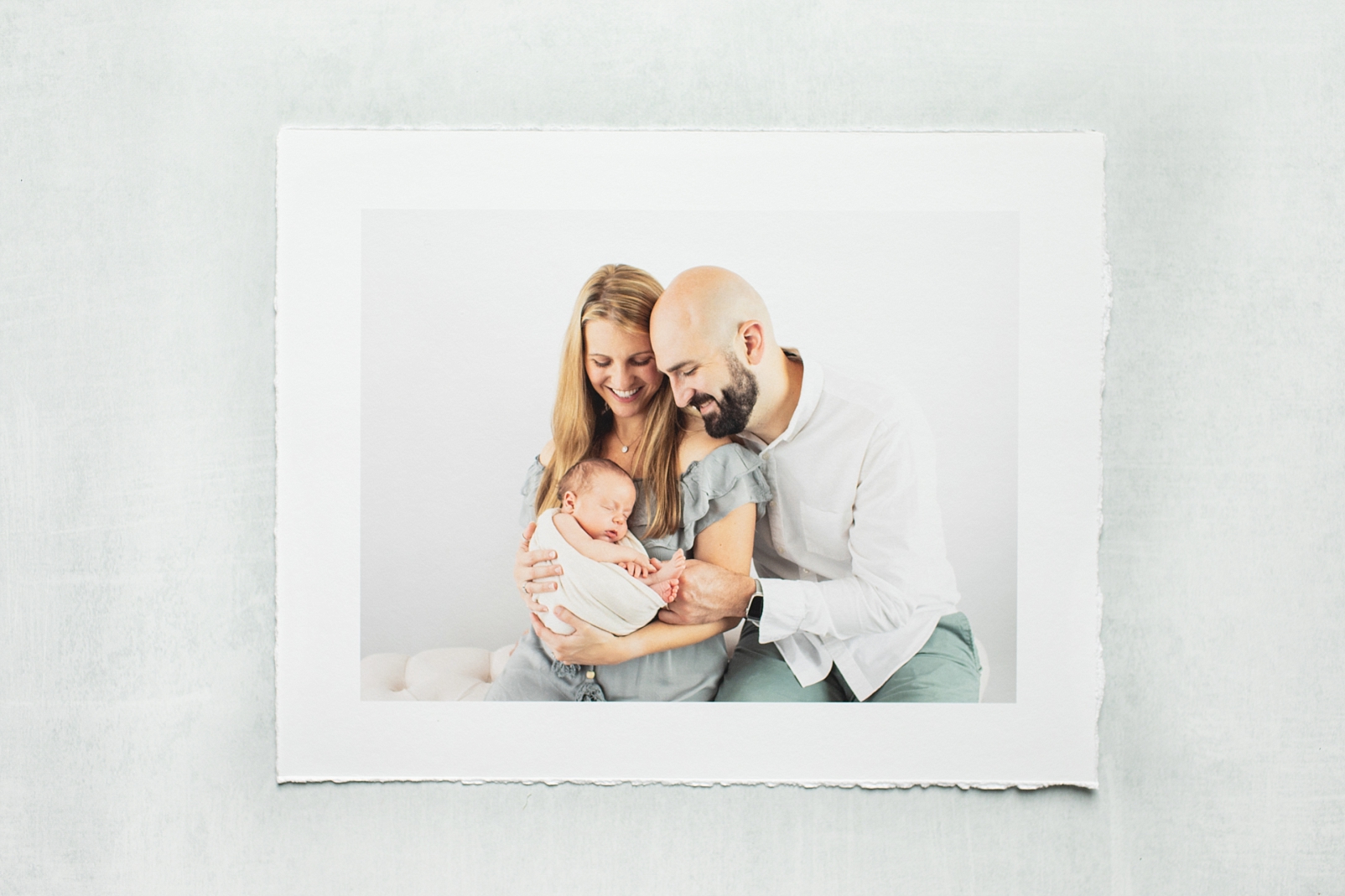 Photographs keep our memories in a Deckled Edge print of a couple holding their baby boy