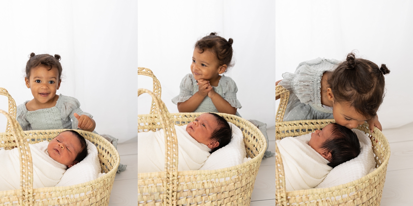 newborn in a Moses basket with his big sister looking over him