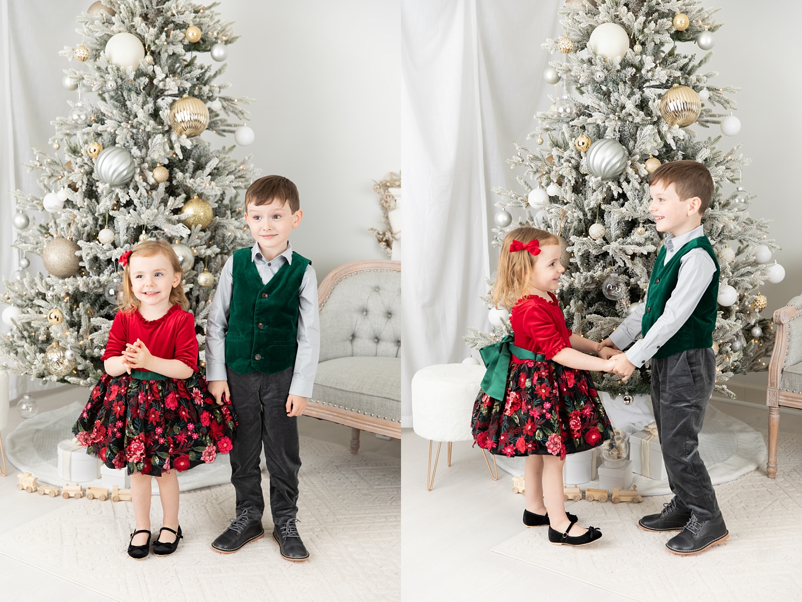 A brother and sister standing in front of the Christmas tree wearing reds and greens