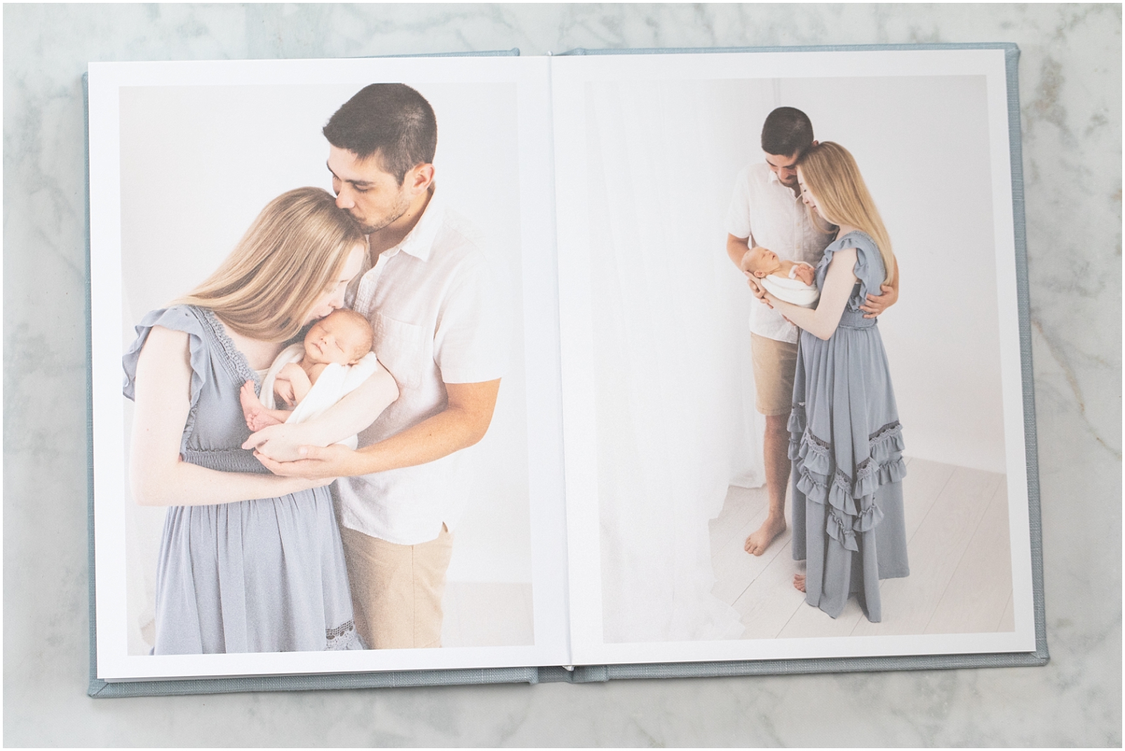 Linen Heirloom Albums | Newborn Photos of a mom and dad holding a baby wrapped in a swaddle