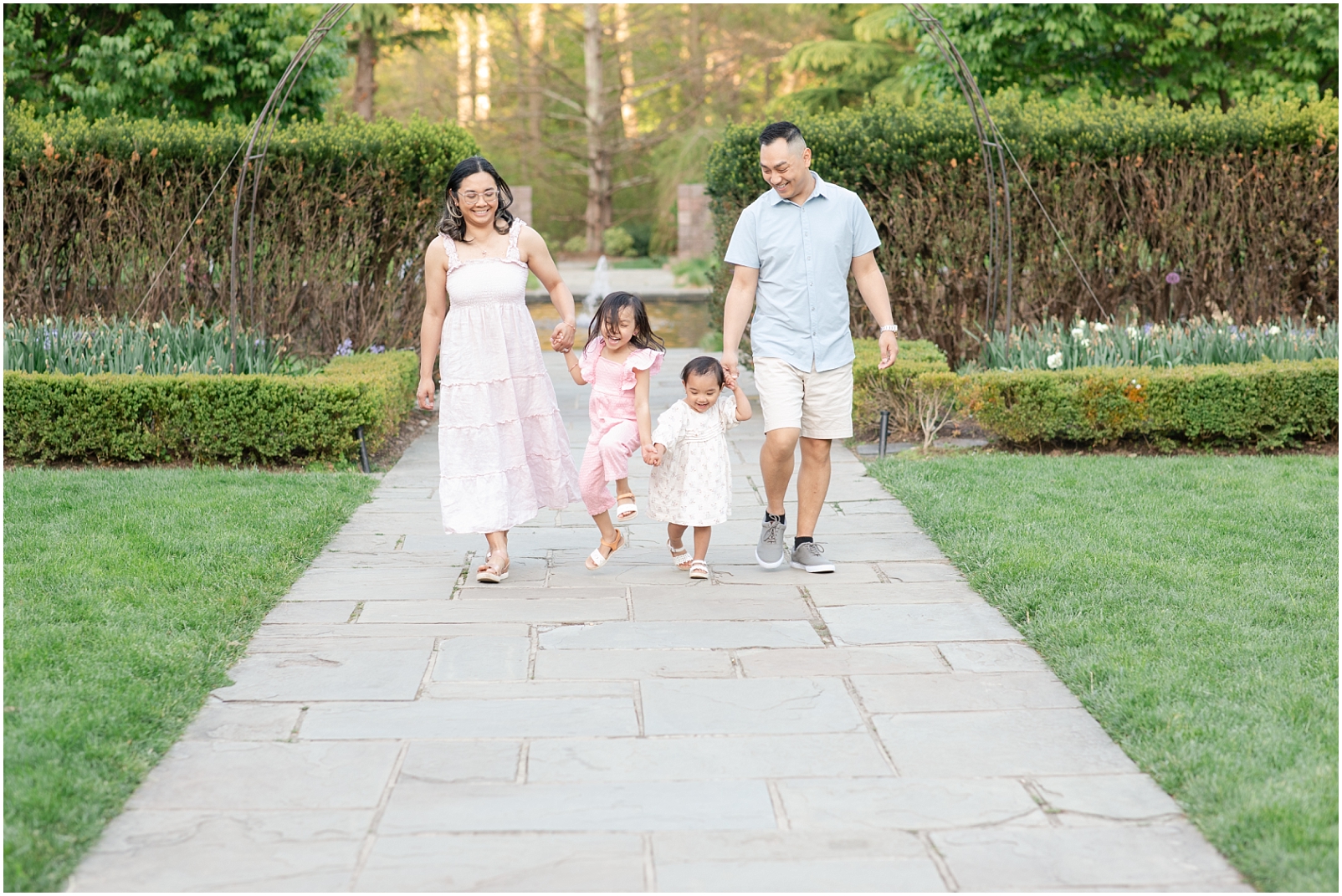 Howard County Photographer portrait of a family walking together on a stone pathway in a garden